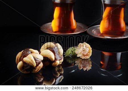 Round Rahat Lukum On The Table, Next To A Cup Of Turkish Tea.