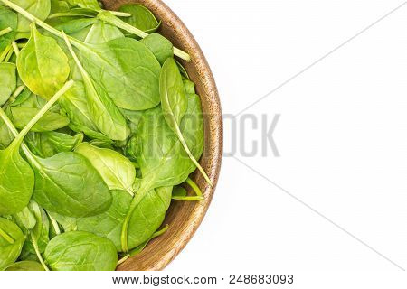 Fresh Baby Spinach Leaves In A Wooden Bowl Top View Isolated On White Background