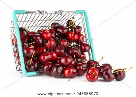 Sweet Bright Red Cherry Out Of A Shopping Basket Isolated On White