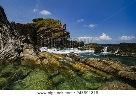 Hidden Beauty Nature Of Kapas Island Located In Malaysia, Magical Rock Formation Over Blue Sky Backg