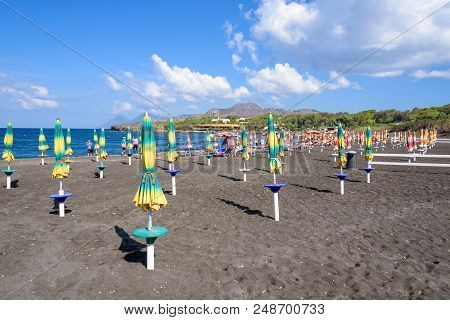 Vulcano Island, Italy - September 9, 2016: First Sunbathers On The Black Beach On Vulcano Island, On