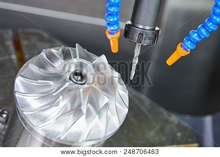 Milling metalworking process. CNC machining of turbine impeller by vertical mill