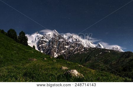 Night Landscape Of Rocky Mountains With Snowy Peaks In Svaneti, Georgia. Night Starry Sky And Mounta