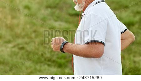 Cropped Photo Of Running Old Man. Model Wearing White Polo Shirt With Dark Blue Stripes, Special Spo