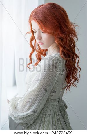 Tender Retro Portrait Of A Young Beautiful Dreamy Redhead Woman.