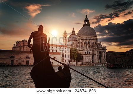 Silhouette Of Venezian Gondolier Punting Gondola In Grand Canal.
