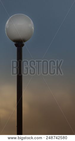 The Street Lamp With The Round Plafond Against The Background Of The Blue Sky, Painted By Golden Lig