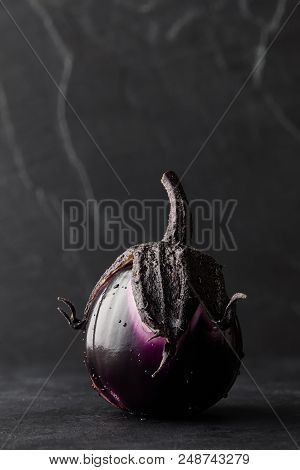 Fresh Italian Type Eggplant Or Aubergine With Water Drops Closeup On Black Background