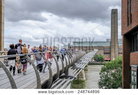 St. Pauls, City, London, Uk - August 3 2017: People Crossing The Millennium Bridge With Tate Modern 