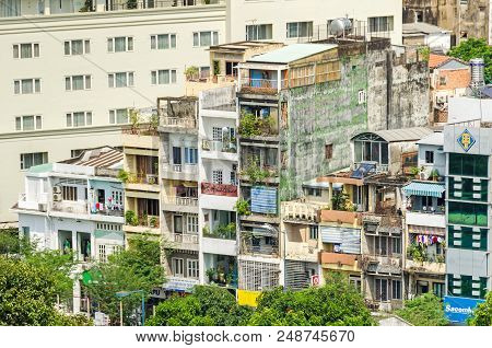 Ho Chi Minh City, Vietnam - 4 April, 2018: A Few Remaining Typical Narrow Old Buildings In A Fast Gr