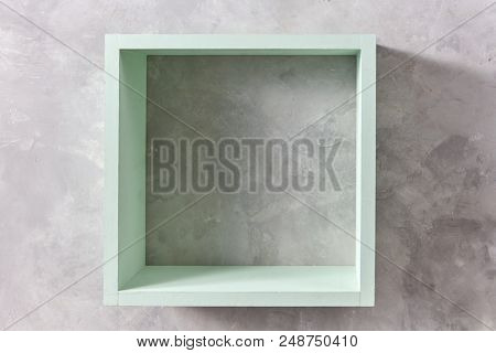 square green wooden wall isolated on gray concrete wall with copy space. Product display template