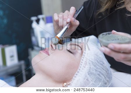 Young Beautiful Girl Receiving Pink Mask In Spa Beauty Salon - Indoors