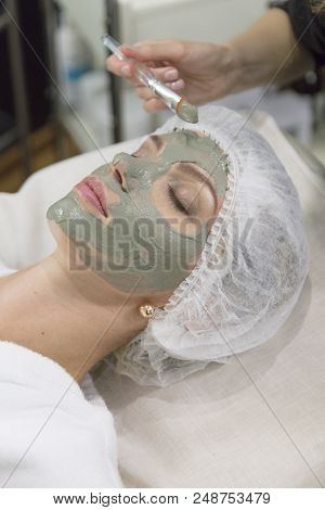 Young Beautiful Girl Receiving Pink Mask In Spa Beauty Salon - Indoors
