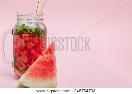 Watermelon Smoothie With Slice Of Fruit And Leaf Of Mint Over Pink Background.