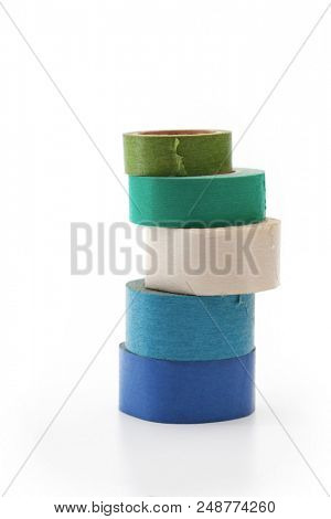 Masking tapes of different colors , stacked up and isolated on white.