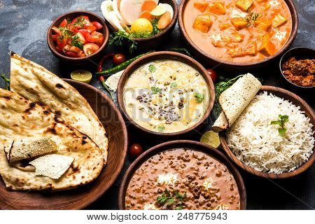 Assorted Indian Food For Lunch Or Dinner, Rice, Lentils, Paneer, Dal Makhani, Naan, Chutney, Spices 