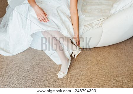 Beautiful Woman Legs In Whitel Shoes. Wedding Dress And Shoes. Morning Of The Bride.