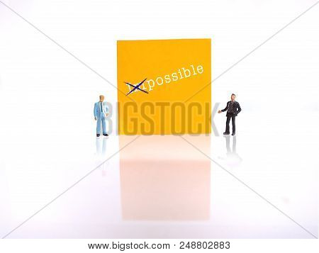 Photo Two Mini Figure Businessman Explaining Change Impossible Into Possible Thing