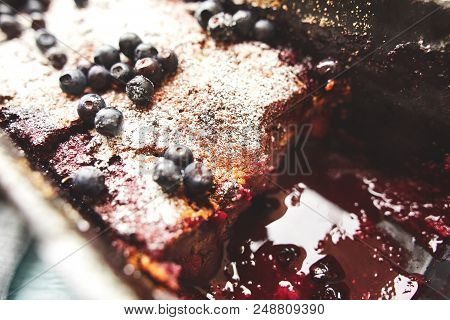 Closeup Berry Crumble In The Baking-tin With Blueberries On The Blue Wooden Table. Top View With Sel