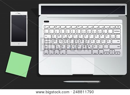 Table With Phone And The Laptop And Leaflets