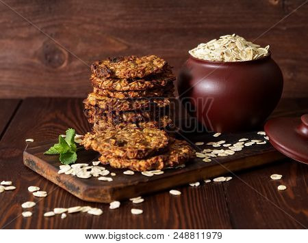 Homemade Oatmeal Cookies With Banana, Oats, Nuts, Eggs And Flour Free On A Brown Dark Wooden Table, 