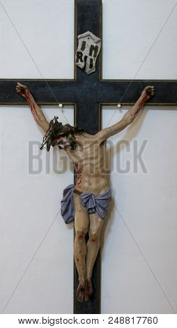PUPNAT, CROATIA - MARCH 21: Cross in the Church of Our Lady of the Snows in Pupnat, Korcula island, Croatia, on March 21, 2017.