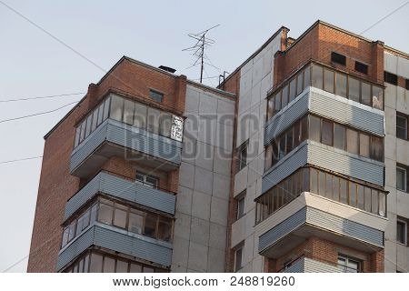 Red Brick Multi Storey Building With Tv Antenna