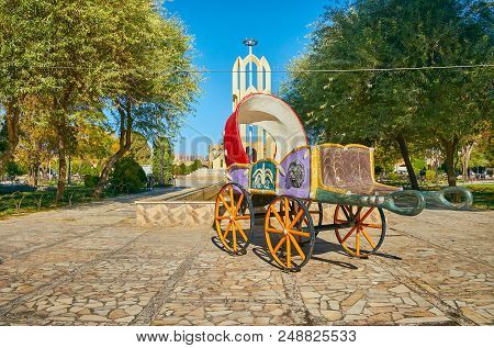 The Traditional Colored Carriage Decorates Tohid Square With Lush Green Trees And Modern Statue On B
