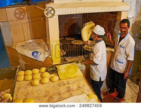Kerman, Iran - October 16, 2017: The Bakers At Work, Preparing Traditional Flatbread In A Large Oven