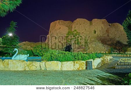 The Evening Walk In Enghelab Park With A View On Ruins Of Adobe Dokhtar Castle, Also Known As Anahit