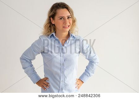 Confused Woman Expressing Disgust And Looking At Camera. Unpleasant Curly-haired Young Lady In Blue 