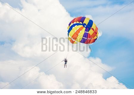 People Playing Parashoot On The Sky Summer Season
