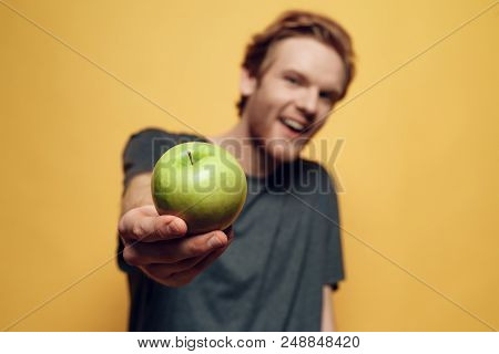 Casual Young Bearded Man Holding Green Apple. Handsome Man With Vegitarian Lifestyle Looking At Came