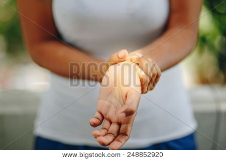 Woman Holding Her Wrist Symptomatic . Health Care Concept