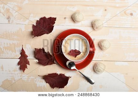 Autumn Coziness Concept. Warm And Cozy Autumn Coffee Time. Red Ceramic Tableware With Beverage, Top 
