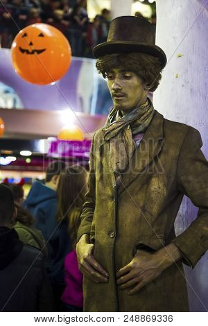 29 Octomber 2018 An Unidentified Man In A Gilded Hat And Raincoat Motionless, Halloween, Chisinau, M