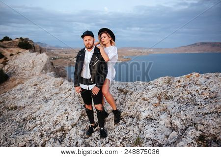 Romantic Summer Love Story On A Sunset In Mountains. Young Girl And Boy In Love.