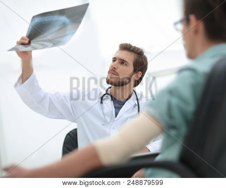 orthopedist examining a radiograph of a patient