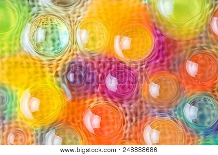 Balls Of Hydrogel On A Fabric Backdrop, Transparent Background Of Multi-colored Balls