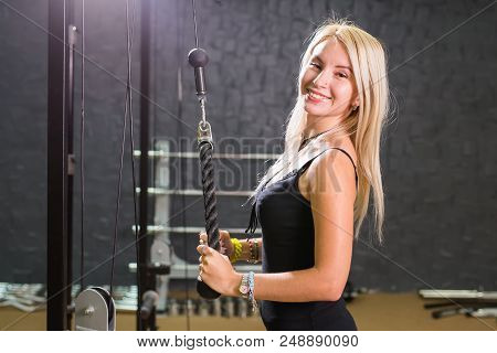 Sport, Fitness, Lifestyle And People Concept - Close Up Of Young Woman Flexing Muscles On Cable Gym 