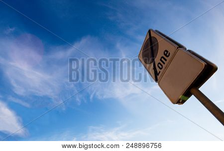 Traffic Sign: No Stopping During Period Indicated, Red Route, Clearway With Blue Sky Background.