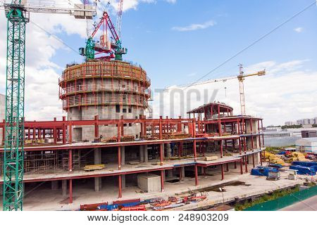 Construction Site With Cranes And Building With Blue Sky Background