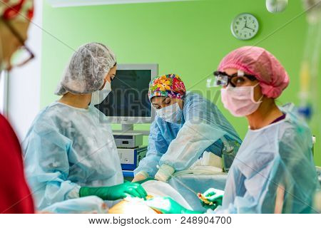 Cosmetic Liposuction Surgery In Actual Operating Room Setting Showing Surgeon Hands And Cannula