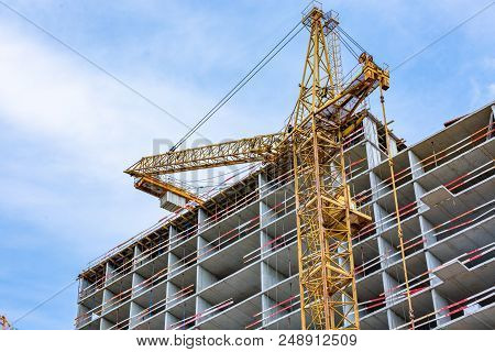 Construction Site With Cranes And Building With Blue Sky Background