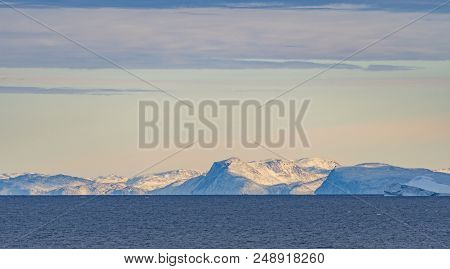Clear Skies Over Distant Peaks In The Vaigat Channel In Western Greenland