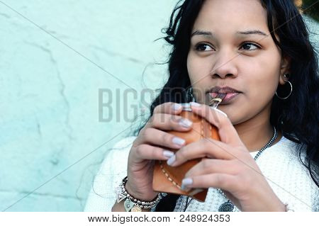 Young Latin Woman Drinking Traditional Yerba Mate Tea.