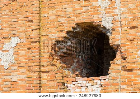 Hole In Old Brick Wall In Abandoned Building