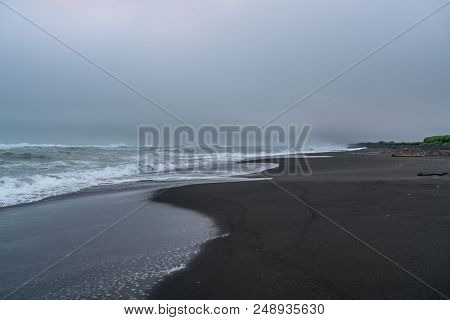 Black Volcanic Sand At Khalaktyrsky Beach Of The Pacific At Kamchatka Peninsula, Near Petropavlovsk-