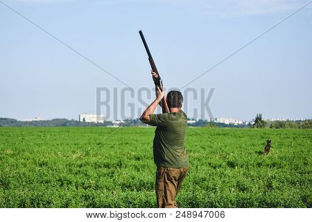 Hunter Shoot With Double Barrel Gun. Summer Time