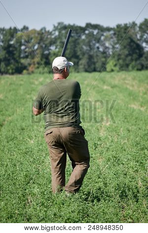 Hunter Shoot With Double Barrel Gun. Summer Time.